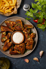 Baked chicken wings. Served with sauce or fries.