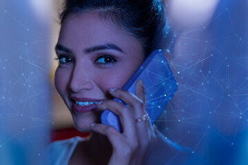 Businesswoman talking on smart phone with virtual icons 