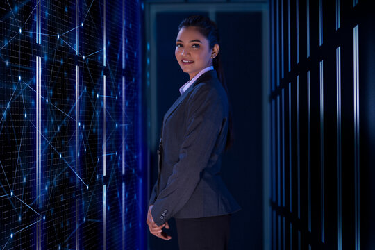 Technician Standing next to the server in the data storage room. 