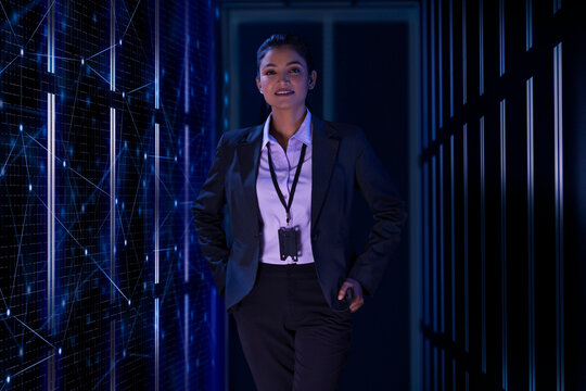 Technician Standing next to the server in the data storage room. 