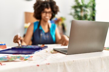 Young african american woman smiling confident having online draw class at art studio