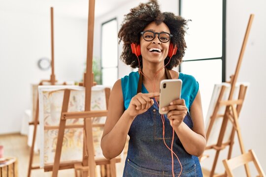 Young african american woman smiling confident listening to music at art studio