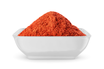 Ground red pepper in white bowl isolated on white. Front view.