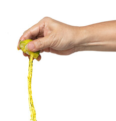 Hand squeezed Green Lime, round green lime squeeze in yellow juice with freshness. Tropical green lime with rough natural surface hold fingers in air. White background Isolated high speed shutter