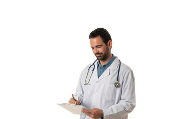 Medical services. Smiling young male doctor In white uniform and stethoscope writing a medical report on a folder isolated on white background