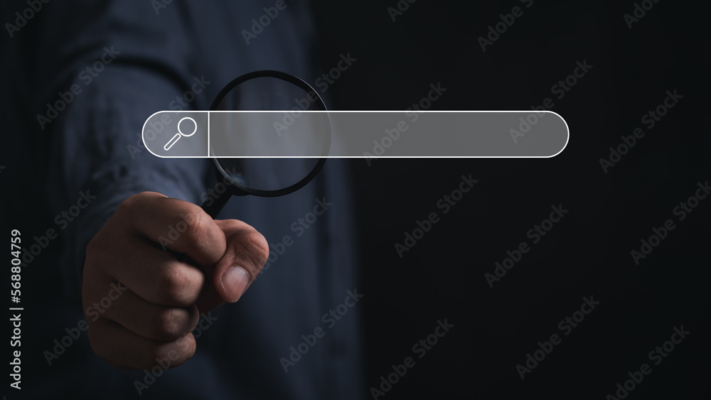 Wall mural hand holding magnifying glass. searching for information. using search console with your website. da