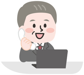 デスクで電話をする会社員のシニア男性 