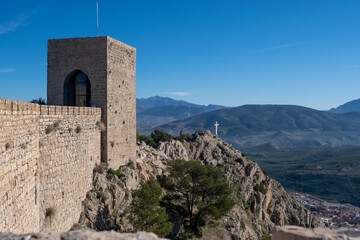 View of the castle of Santa Catalina with the cross in the distance and the mountain in the background