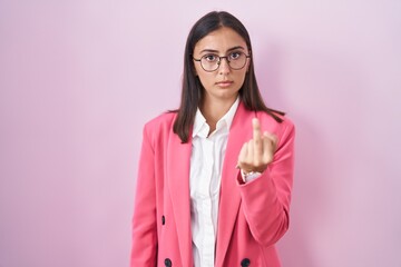 Young hispanic woman wearing business clothes and glasses showing middle finger, impolite and rude...