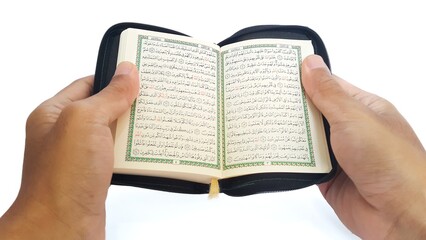 Man reading the holy quran. Hand holding a Holy Quran on white background.