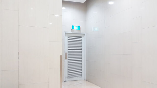 A White Emergency Exit Door In The Shopping Mall Building