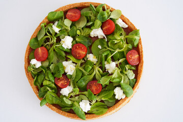 Cake of vegetables lying on the white background. Healthy cooking concept