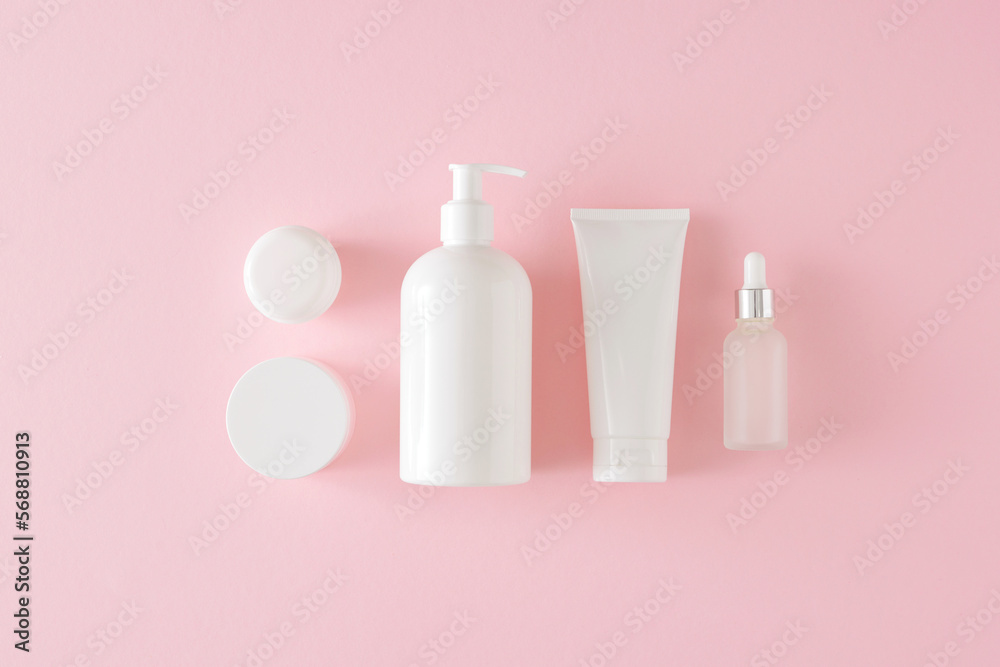 Wall mural skin care products concept. flat lay composition made of white cosmetic bottles, cream jars and drop