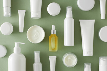 Skin care products concept. Flat lay photo of cosmetic bottles without label, cream jar, dropper...