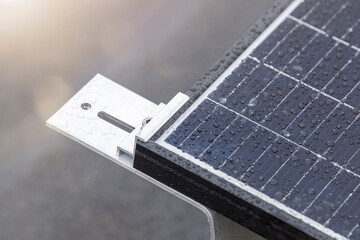 Bracket for mounting solar panels. Mounting a solar panel close-up on the roof of a residential...