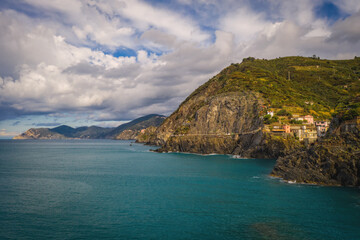 Beautiful view of of rocky mountainous coast and blue sea near Riomaggiore, Italy. September 2022, aerial drone picture