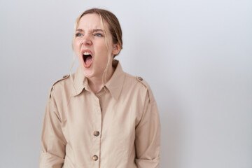 Obraz na płótnie Canvas Young caucasian woman wearing casual shirt angry and mad screaming frustrated and furious, shouting with anger. rage and aggressive concept.