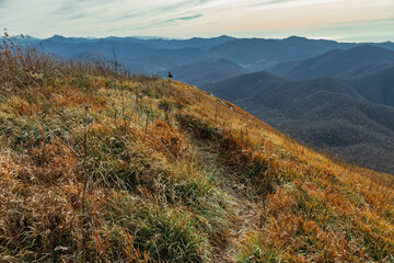 Mountain pass, mountain range. The mountain range of the Caucasus against the background of clouds. Beautiful mountain landscape. View from a great height in a picturesque place of the Caucasus. 