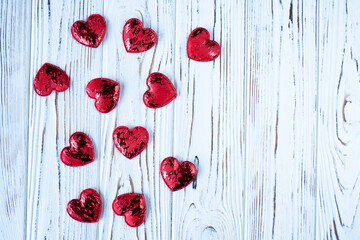 red hearts on a light wooden background