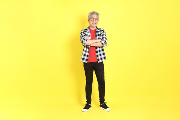 Fototapeta premium The 40s adult Asian man with casual dressed standing on the yellow background.