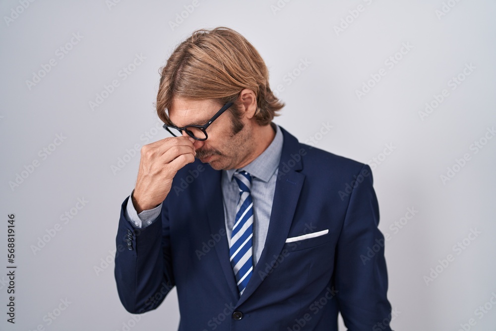 Sticker Caucasian man with mustache wearing business clothes tired rubbing nose and eyes feeling fatigue and headache. stress and frustration concept.