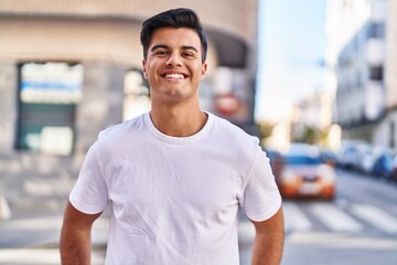 Fototapeta na wymiar Young hispanic man smiling confident standing at street