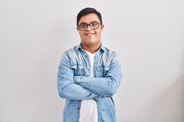 Young hispanic man with down syndrome wearing casual denim jacket over white background happy face...