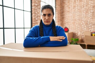Young hispanic woman moving to a new home skeptic and nervous, frowning upset because of problem....