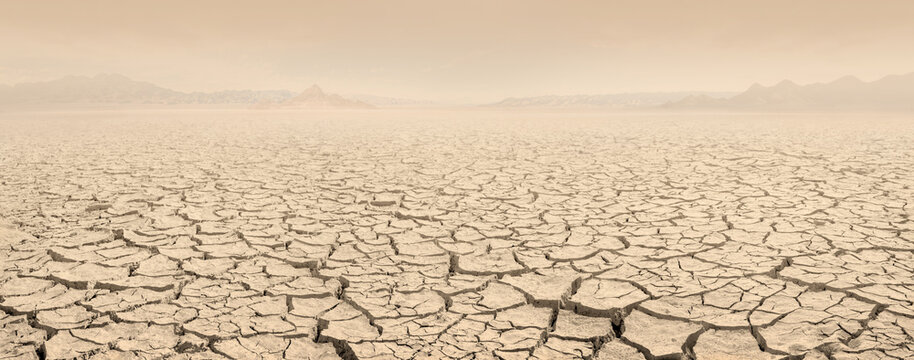 Desertification concept landscape. Dried lakebed panorama with sky filled with clouds of dust - Powered by Adobe
