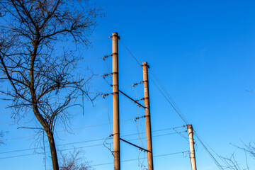 Electric pole with a linear wire against the blue sky close-up. Power electric pole.