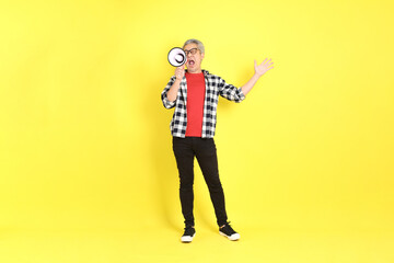 The 40s adult Asian man with casual dressed standing on the yellow background.