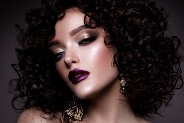 Fototapeta premium Brunette girl with long and shiny curly hair . Beautiful model woman with wavy hairstyle 