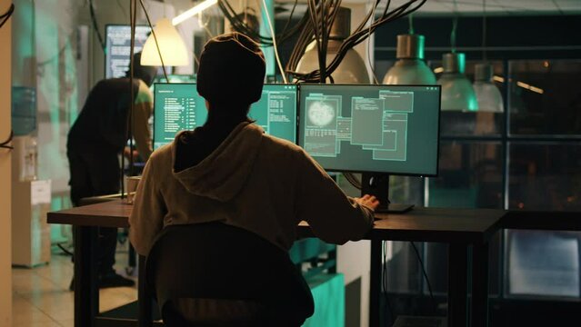 Hackers doing illegal activity to steal government data on multi monitors, breaking into computer system with trojan virus. Thieves committing cyberattack and cyberbullying, harassment.