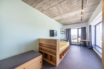 Simple student-style dorm bedroom. Hostel dormitory room. Campus