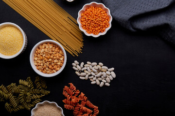 Obraz na płótnie Canvas Assortment of gluten-free food - fusilli pasta, spaghetti, cereals. Concept of FODMAP, paleo, keto, diet, long carbohydrates, copy space