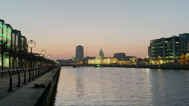 Custom House quay, Dublin Sean o'Casey bridge action at dusk, liffey river, view from the quays, horizontal.