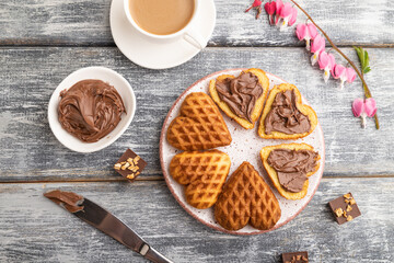 Fototapeta premium Homemade waffle with chocolate butter on a gray wooden. top view, flat lay.