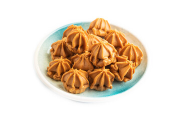 Homemade soft caramel fudge candies isolated on white, side view.