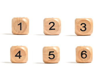 Six wooden cubes with numbers for board games white background.