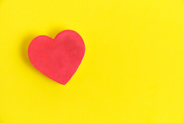 Red heart bright yellow background.