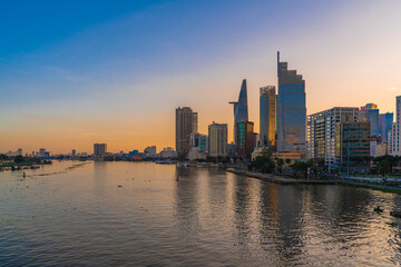 Obraz premium Ho Chi Minh City, Viet Nam 02 Jan 2023: Beautiful Sunset at district 1, view to Bitexco tower with Vietnam flag on the top building. One of the famous buildings in ho chi minh city