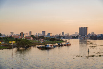 Fototapeta premium Ho Chi Minh City, Viet Nam 02 Jan 2023: Beautiful Sunset at district 1, view to Bitexco tower with Vietnam flag on the top building. One of the famous buildings in ho chi minh city