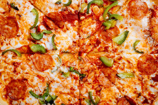 Fresh classic pizza with tomato sauce, mozzarella, spicy chorizo, bell peppers. Food textures top view, close-up