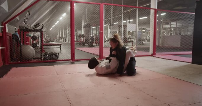 Female wrestlers sparring in gym