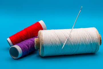 colored threads on a blue background