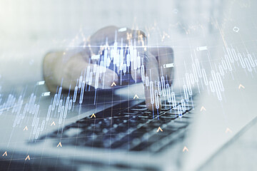 Multi exposure of abstract financial diagram with world map and with hand typing on computer keyboard on background, banking and accounting concept