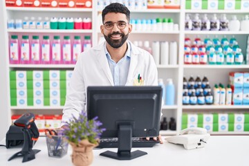 Hispanic man with beard working at pharmacy drugstore with a happy and cool smile on face. lucky person.