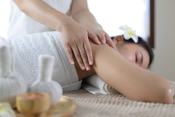 Masseur doing massage on woman body in the spa salon. Body care and beauty treatment concept.