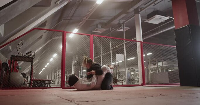 Female wrestlers sparring in gym