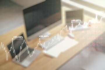 Multi exposure of abstract financial graph and modern desktop with pc on background, financial and trading concept